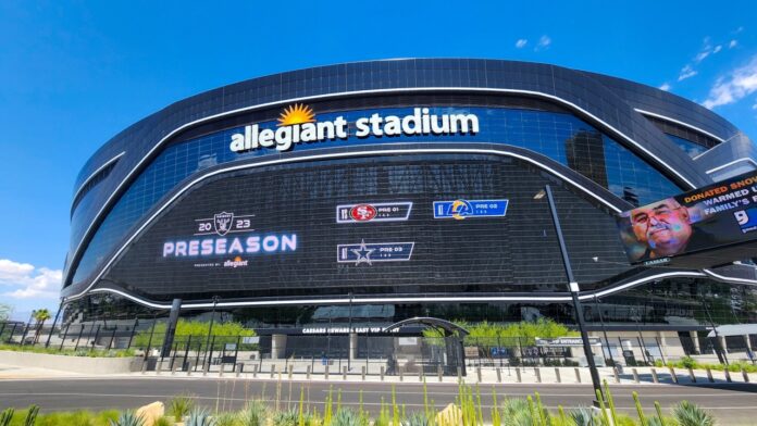 A gorgeous spring landscape at Allegiant Stadium surrounded by lush green trees and plants and a gorgeous blue sky with clouds in Las Vegas Nevada USA.