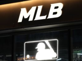 Close up Major League Baseball (MLB) sign at night.