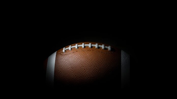 Shutterstock Superbowl Evgeniy Zhukov 788912617 American football with a dark background