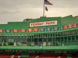 The press box at historic Fenway Park, with banners representing the team's division and World Series championships.