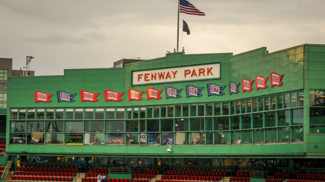 The press box at historic Fenway Park, with banners representing the team's division and World Series championships.