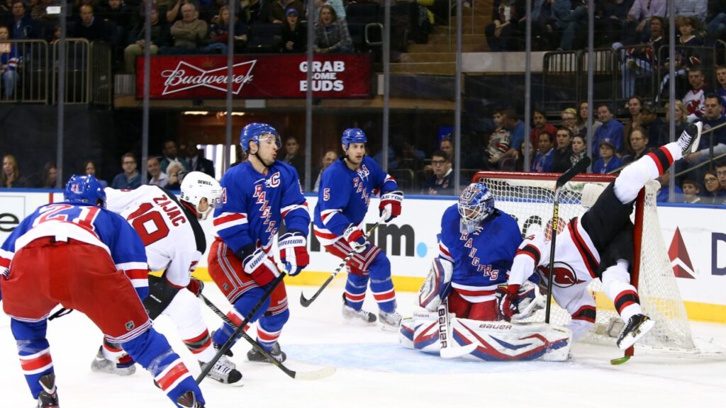New Jersey Devils center Travis Zajac (19) and left wing Patrik Elias (26) against New York Rangers goalie Henrik Lundqvist (30) at Madison Square Garden.