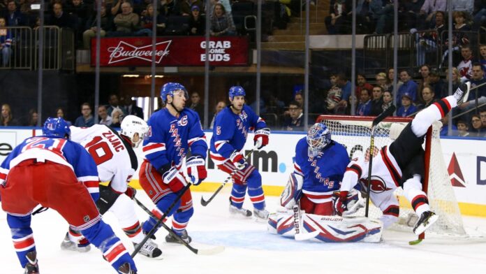 New Jersey Devils center Travis Zajac (19) and left wing Patrik Elias (26) against New York Rangers goalie Henrik Lundqvist (30) at Madison Square Garden.