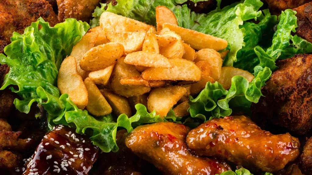 fat junk food closeup fast food and unhealthy eating concept - Gameday Chatter Chicken wings and other snacks.