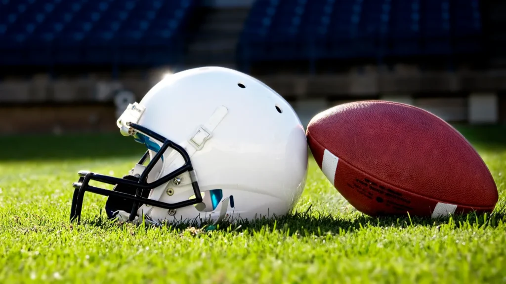 Football helmet on a stadium field. 