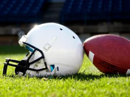 Football helmet on a stadium field.