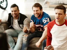 Male friends watching American football.
