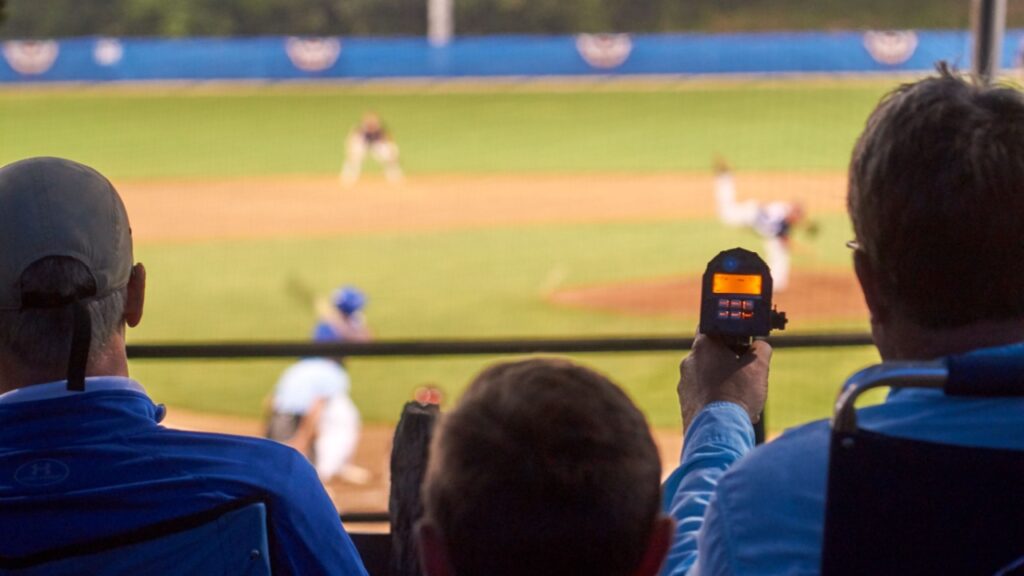 Talent scouts with radar guns during a baseball game in Cape Cod. 