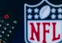 The Hidden Strategy Behind NFL Scheduling Each Season Man with a remote and NFL on the TV.