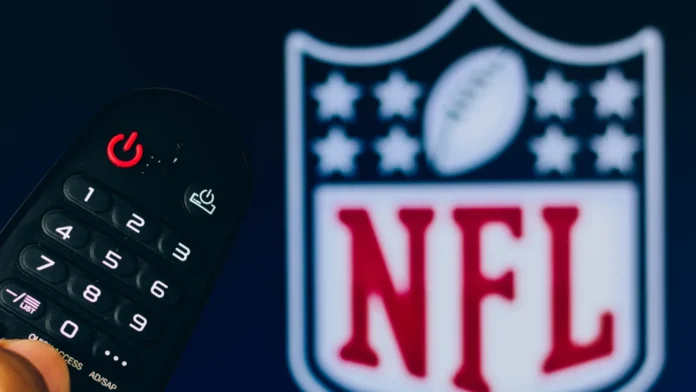 february 21 2022 brazil in this photo illustration a closeup Man with a remote and NFL on the TV.