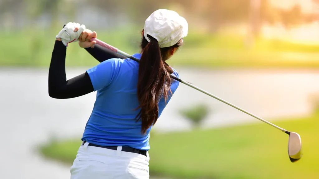 Golfer hitting golf shot.