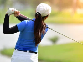 Golfer hitting golf shot.