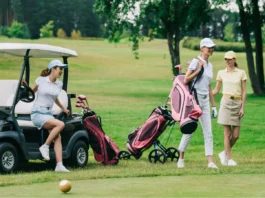 group of female golf players in caps with golf equipment