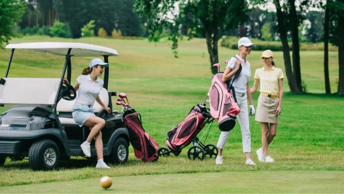 group of female golf players in caps with golf equipment