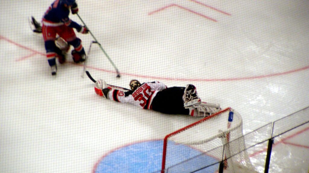 Devils goalie Martin Brodeur dives and stretches to make a save against the Rangers in a preseason game at Madison Square Garden October 2, 2005 in New York, NY.