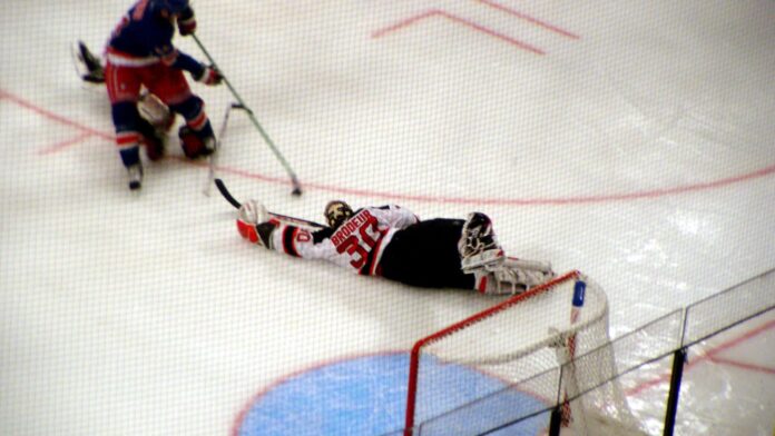 Devils goalie Martin Brodeur dives and stretches to make a save against the Rangers in a preseason game at Madison Square Garden October 2, 2005 in New York, NY.