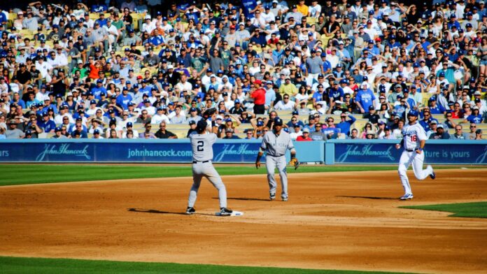 Shutterstock_Yankees vs Dodgers_ 60797017 New York Yankees second baseman Robinson Cano and shortstop Derek Jeter turn a double play ahead of Dodger outfielder Andre Ethier