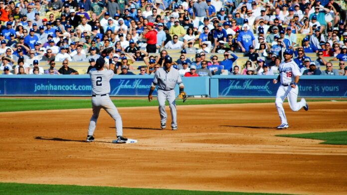 Shutterstock_Yankees vs Dodgers_ 60797017 New York Yankees second baseman Robinson Cano and shortstop Derek Jeter turn a double play ahead of Dodger outfielder Andre Ethier