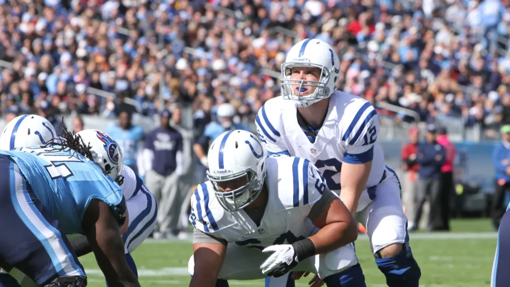 NFL quarterback readies to snap the ball behind the center.
