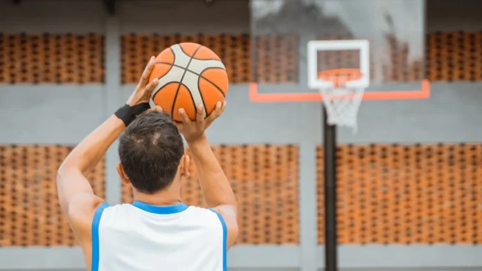 Back view of a male basketball player holding the ball.