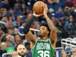 Boston Celtics player, Marcus Smart, 36 shoots a three point shot.