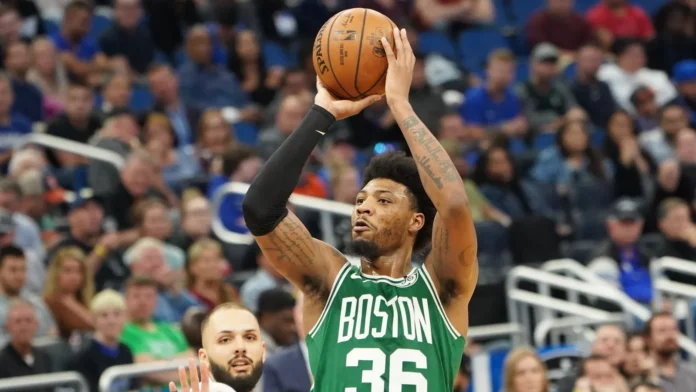 Boston Celtics player, Marcus Smart, 36 shoots a three point shot.
