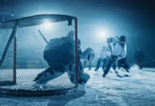 Ranking the greatest goalies in NHL history An ice hockey rink arena with a goalie against forward player.