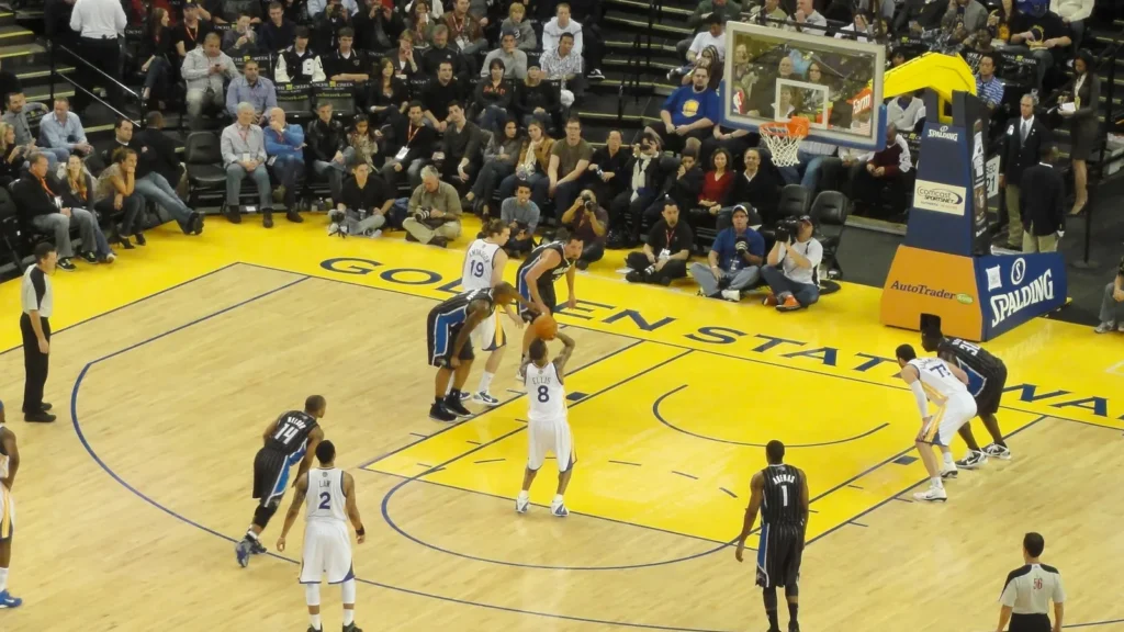 Golden State Warrior team player taking a shot.