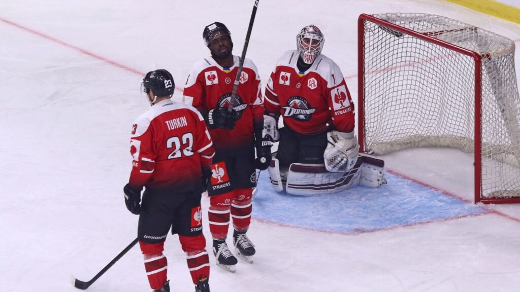 Hockey players grouped together during game.