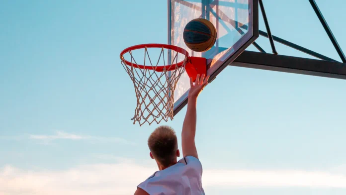 a young basketball player throws a ball into a basketball