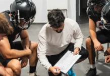 Jim Leonhard returns to Bills as new defensive coordinator american football coach showing strategy on a clipboard to his