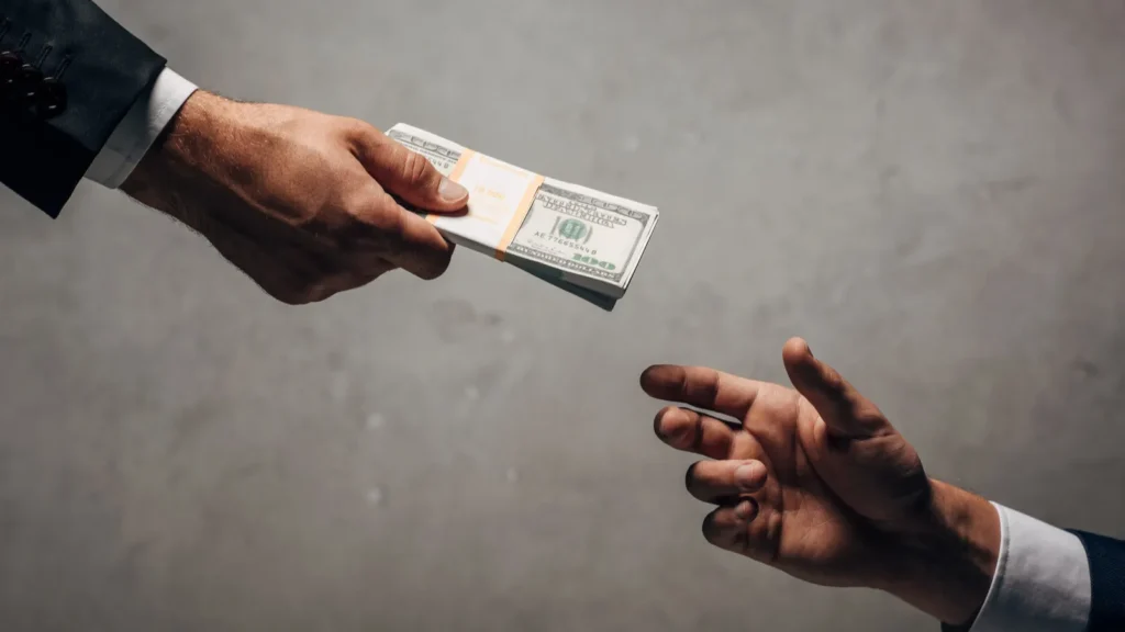 Cropped view man giving money.