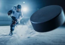 Vegas brings three-game slide into game against Seattle Kraken ice hockey rink arena professional player shooting the puck with