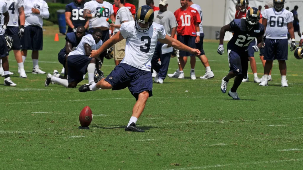 A football player going to hit a ball.