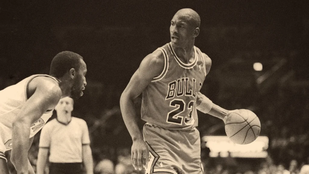 Michael Jordan dribbling the basketball while facing tight defensive pressure during an NBA game.