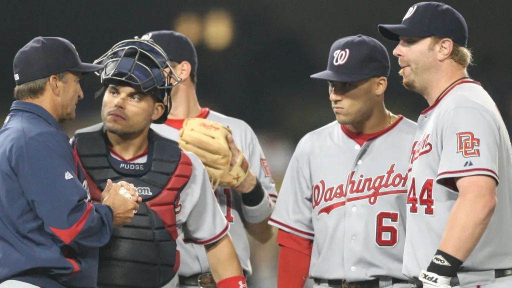 Washington Nationals coaching staff and players discuss strategy during a mound meeting.