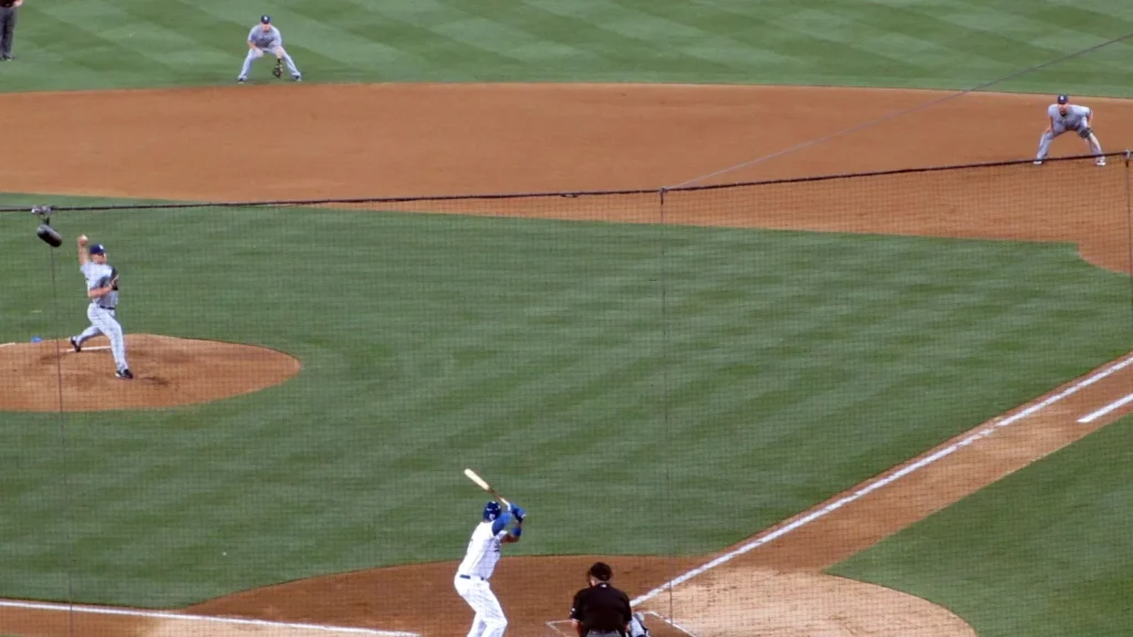 A pitcher delivers a pitch to a batter at home plate during a baseball game.