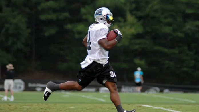 spartanburg sc july 28 carolina panther football player deangelo A football player sprinting with the ball during a game.