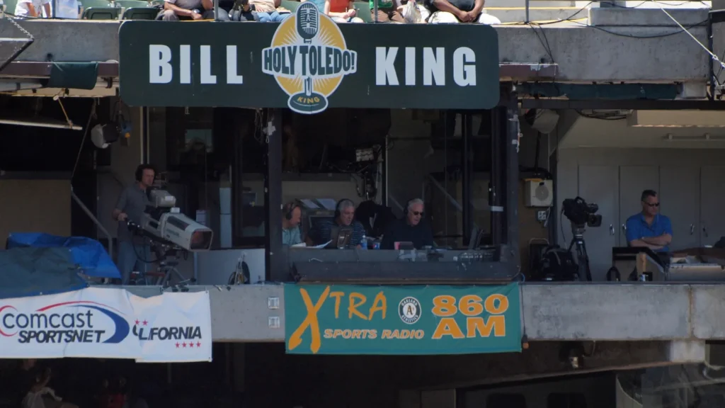 Baseball game broadcast booth with production team.