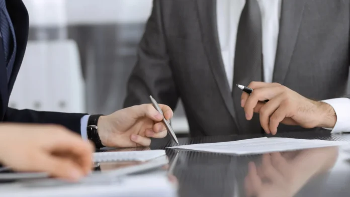 People signing a contract.