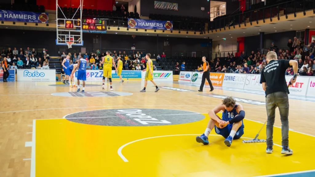 Basketball players in action during a professional game at indoor arena.