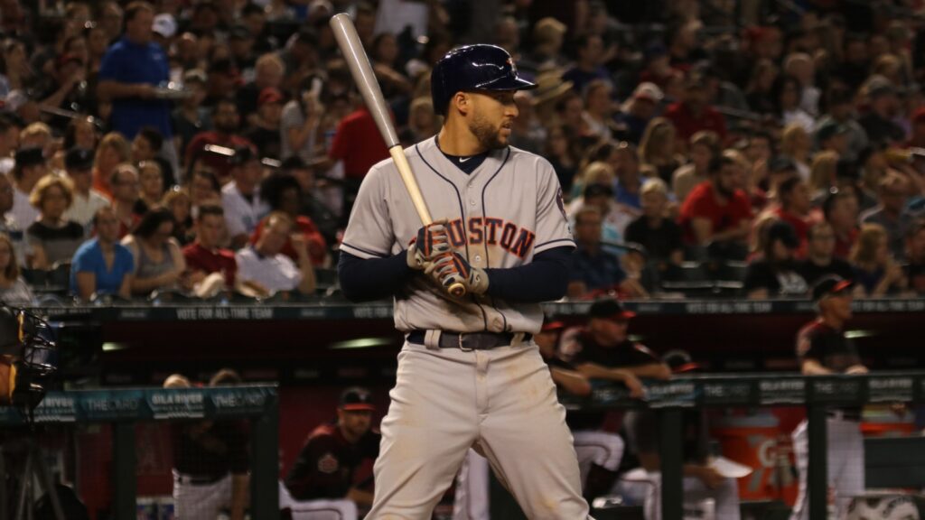 Carlos Correa holding a baseball bat during a game.