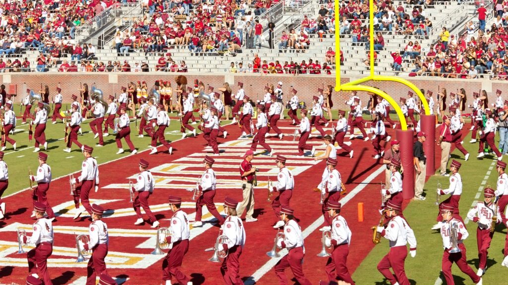 Marching band halftime performance at a football stadium.