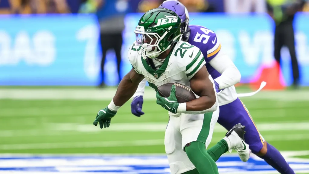 breece hall of the new york jets incepts the ball