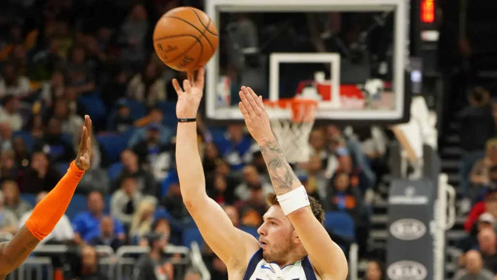 dallas mavericks player luka doncic 77 shoots a three during