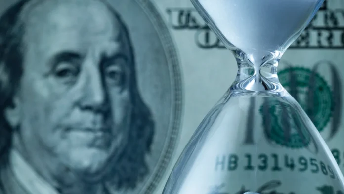 dollar bill with egg timer or hourglass with running sand dollar bill with egg timer or hourglass with running sand