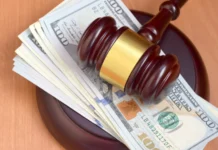 Judge gavel and money on brown wooden table