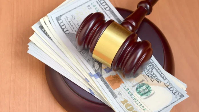 Judge gavel and money on brown wooden table