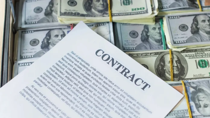 Top-shot of a contract above piles of money