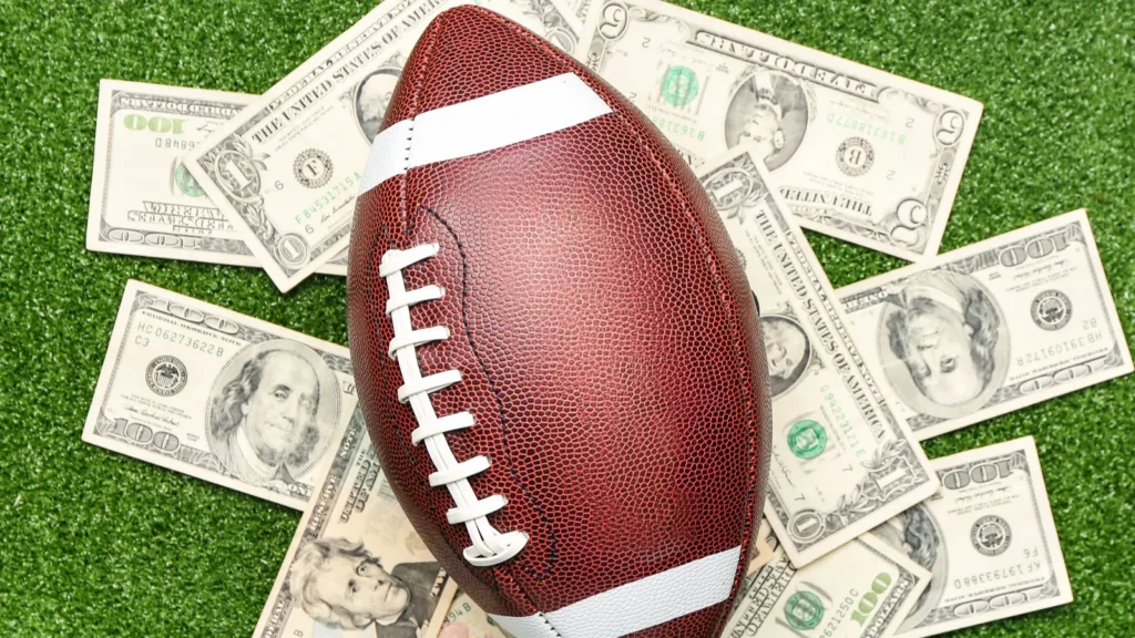 money and rugby ball on color background concept of sports